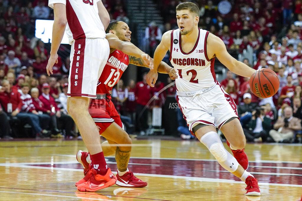Andy Manis Wisconsin's Trevor Anderson (12) drives against Ohio State's CJ Walker (13) during the second half of an NCAA college basketball game Sunday, Feb. 9, 2020, in Madison, Wis. (AP Photo/Andy Manis)