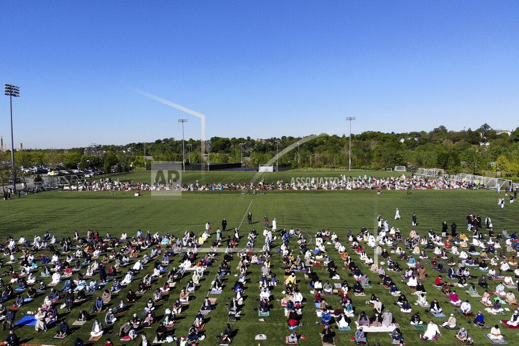 Seth Wenig More than 2000 people participate in Eid al-Fitr prayers in Overpeck County Park in Ridgefield Park, N.J., Thursday, May 13, 2021. Millions of Muslims across the world are marking a muted and gloomy holiday of Eid al-Fitr, the end of the fasting month of Ramadan - a usually joyous three-day celebration that has been significantly toned down as coronavirus cases soar. (AP Photo/Seth Wenig)
