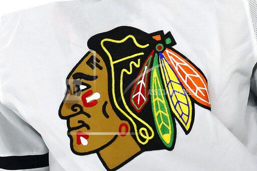 FILE - In this May 3, 2021, file photo, the Chicago Blackhawks logo is displayed on a jersey in Raleigh, N.C. The Blackhawks are holding a briefing Tuesday, Oct. 26, 2021, to discuss the findings of an investigation into allegations that an assistant coach sexually assaulted a player in 2010. (AP Photo/Karl B DeBlaker, File)