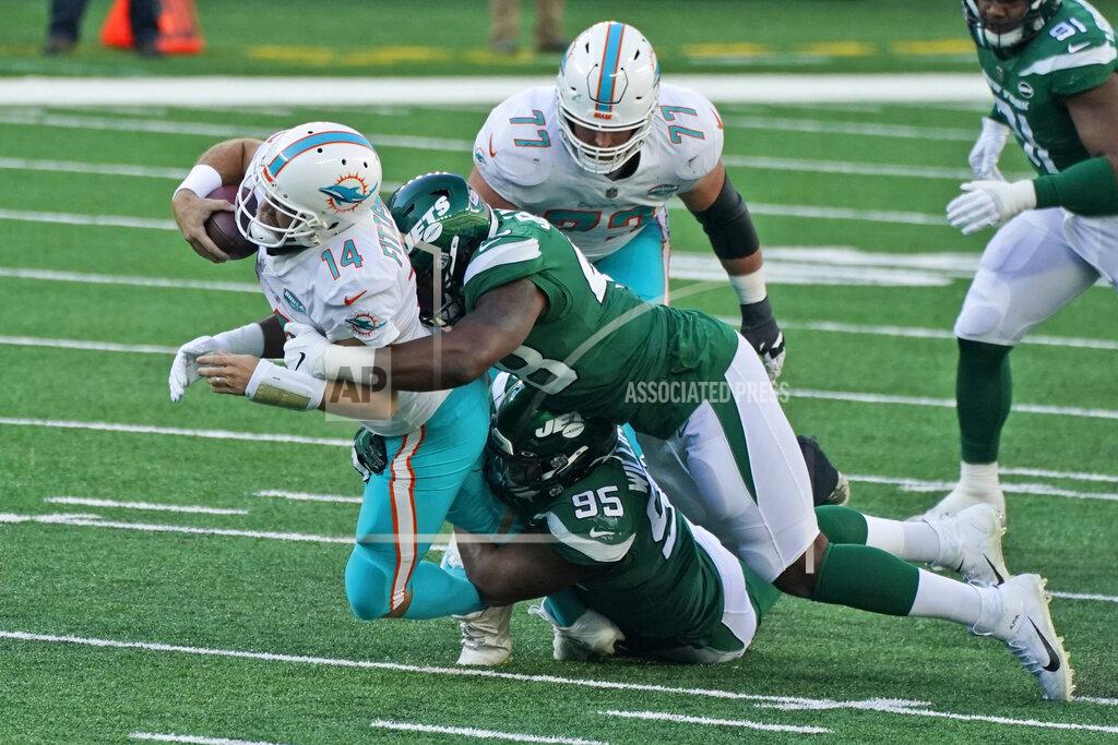 Corey Sipkin New York Jets defense tackles Miami Dolphins quarterback Ryan Fitzpatrick, left, during the first half of an NFL football game, Sunday, Nov. 29, 2020, in East Rutherford, N.J. (AP Photo/Corey Sipkin)