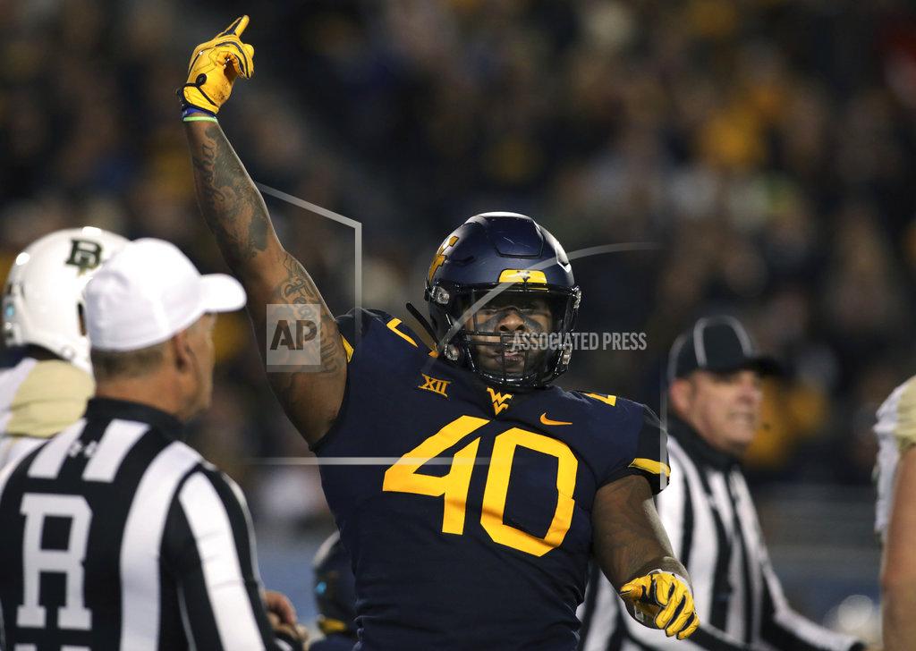 Ray Thompson West Virginia defensive lineman Kenny Bigelow Jr. (40) celebrates making a tackle during the first half of an NCAA college football game against Baylor, Thursday, Oct. 25, 2018, in Morgantown, W.Va. (AP Photo/Raymond Thompson)