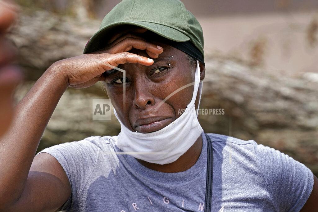 Gerald Herbert Linda Smoot, who evacuated from Hurricane Laura in a pickup truck with eight others, reacts as they return to see their homes, in Lake Charles, La., in the aftermath of the hurricane, Sunday, Aug. 30, 2020. (AP Photo/Gerald Herbert)