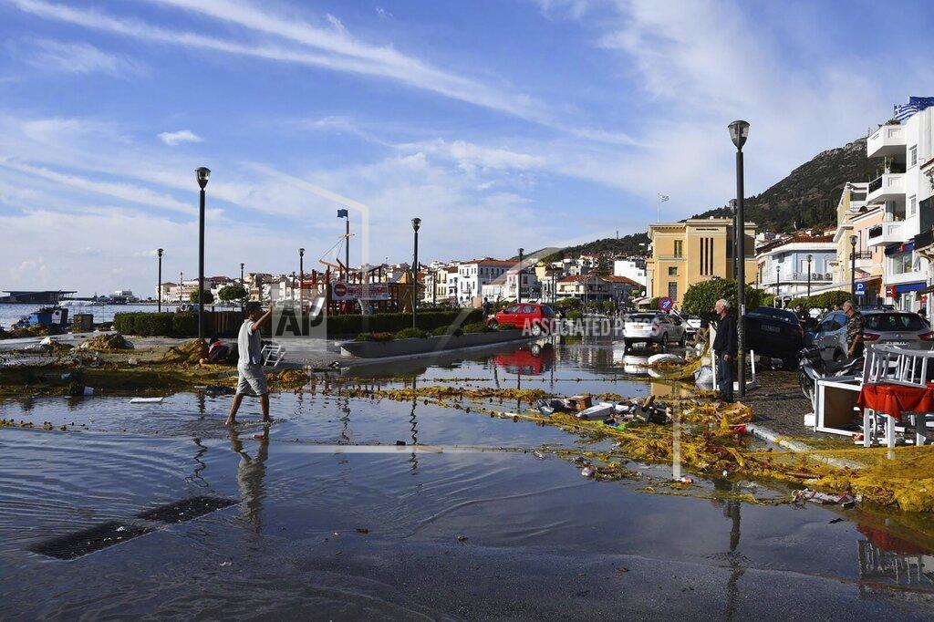 Michael Svarnias Seawater covers a road after an earthquake at the port of Vathi on the eastern Aegean island of Samos, Greece, Friday, Oct. 30, 2020. A strong earthquake struck in the Aegean Sea between the Turkish coast and the Greek island of Samos as the magnitude 6.6 earthquake was centered in the Aegean at a depth of 16.5 kilometers, or 10.3 miles.(AP Photo/Michael Svarnias)