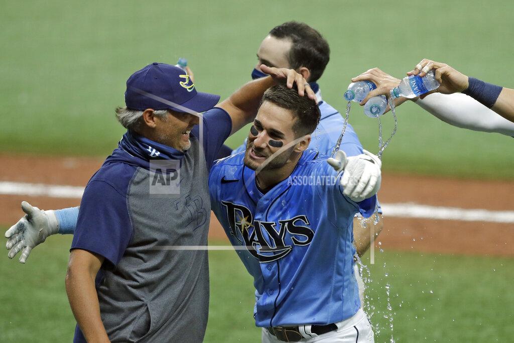 Chris O'meara CORRECTS TO TRIPLE, INSTEAD OF DOUBLE - Tampa Bay Rays' Kevin Kiermaier, right, hugs manager Kevin Cash after Kiermaier hit a two-run walkoff triple off Toronto Blue Jays relief pitcher Shun Yamaguchi during the 10th inning of a baseball game Sunday, July 26, 2020, in St. Petersburg, Fla. The Rays won 6-5. (AP Photo/Chris O'Meara)