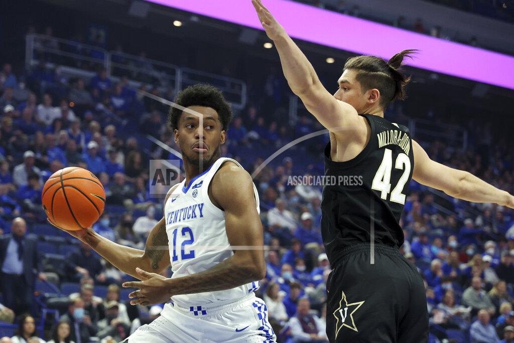 James Crisp Kentucky's Keion Brooks Jr. (12) prepares to pass the ball as Vanderbilt's Quentin Millora-Brown (42) defends during the first half of an NCAA college basketball game in Lexington, Ky., Wednesday, Feb. 2, 2022. (AP Photo/James Crisp)