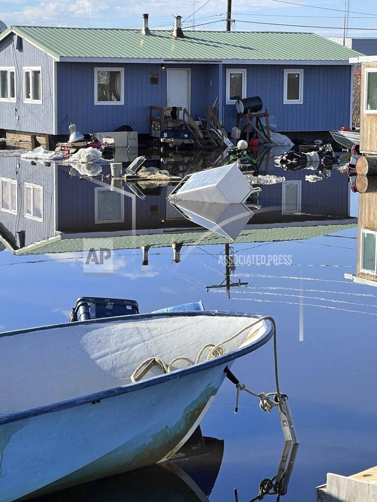 Nathan Hadley Jr. This photo provided by Nathan Hadley Jr. shows flooding in the village of Buckland, Alaska, on Thursday, May 13, 2021. An ice jam on the Buckland River, a half mile below the community, has caused the entire village of about 500 residents in northwest Alaska to be completely inundated. (Nathan Hadley Jr. via AP)