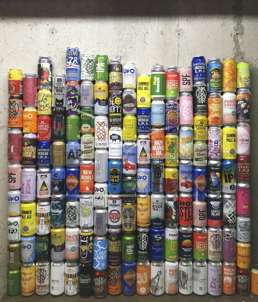 This Jan. 1, 2021 photo shows a collection of empty beer cans, consumed during the pandemic, at a home in North Andover, Mass. This year's Dry January came as many people had seen an uptick in their alcohol intake. Addiction treatment experts note that a month of forced sobriety might not have a lasting impact and could lead to binge drinking in February. But others believe the annual show of sobriety can’t hurt. (Mary Schwalm via AP)