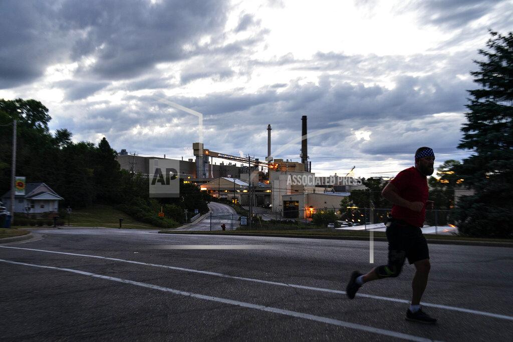 David Goldman A jogger runs past the Midwest Paper Group mill in Little Chute, Wis., part of the greater Appleton area, Monday, Aug. 17, 2020. By almost any measure, President Donald Trump's promises of an economic revival in places like Appleton have gone unfulfilled. The area has lost about 8,000 jobs since he got elected. The state that is vital for Trump's victory had more jobs a decade ago when the country was still ailing from the Great Recession than it did in July.(AP Photo/David Goldman)