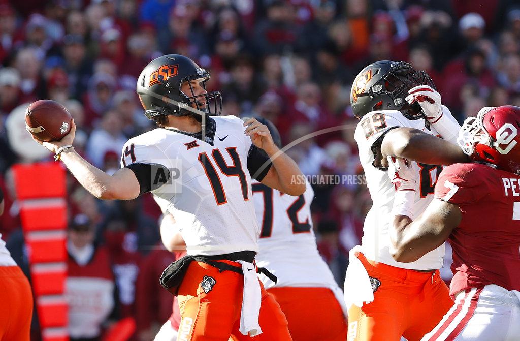 Alonzo Adams Oklahoma State quarterback Taylor Cornelius (14) passes against Oklahoma in the first half of an NCAA college football game in Norman, Okla., Saturday, Nov. 10, 2018. (AP Photo/Alonzo Adams)