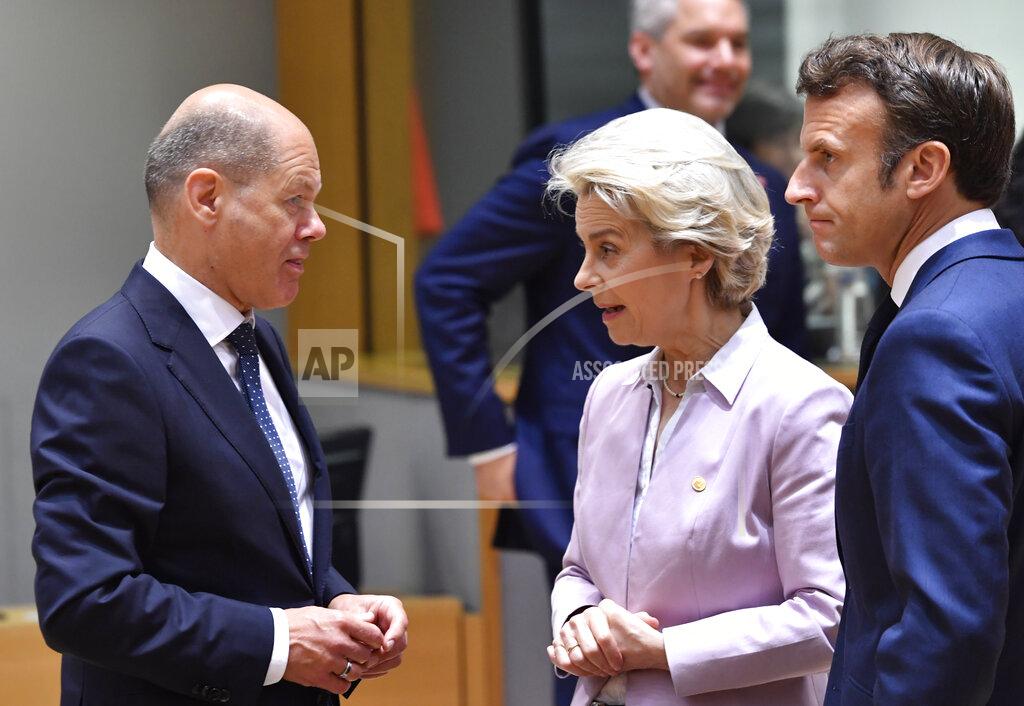 Geert Vanden Wijngaert European Commission President Ursula von der Leyen, center, and French President Emmanuel Macron, right, speak with German Chancellor Olaf Scholz during a round table meeting at an EU summit in Brussels, Thursday, June 23, 2022. European Union leaders are expected to approve Thursday a proposal to grant Ukraine a EU candidate status, a first step on the long toward membership. The stalled enlargement process to include Western Balkans countries in the bloc is also on their agenda at the summit in Brussels. (AP Photo/Geert Vanden Wijngaert)