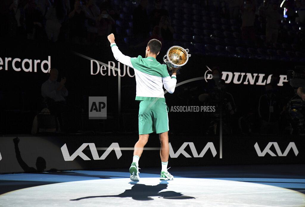 Andy Brownbill Serbia's Novak Djokovic holds the Norman Brookes Challenge Cup aloft after defeating Russia's Daniil Medvedev in the men's singles final at the Australian Open tennis championship in Melbourne, Australia, Sunday, Feb. 21, 2021.(AP Photo/Andy Brownbill)