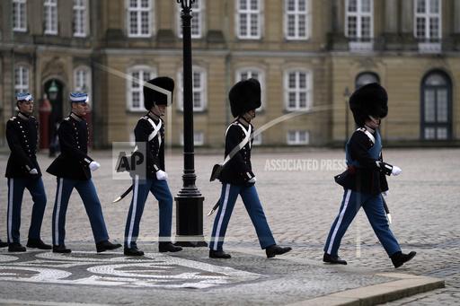 FILE -A changing of the guard at The Amalienborg Palace, home of the Danish Royal family in Copenhagen, Denmark Monday, Feb. 21, 2022. The Danish defense said Wednesday that they will remove the mandatory heights for men and women serving with the Danish Royal Life Guards, chiefly known for serving as a ceremonial unit outside Denmark&rsquo;s royal palaces. (AP Photo/Alastair Grant, File)