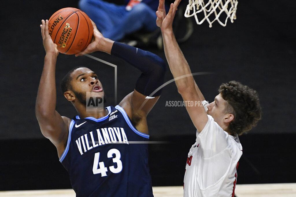 Jessica Hill Villanova's Eric Dixon, left, shoots over Hartford's Hunter Marks in the first half of an NCAA college basketball game, Tuesday, Dec. 1, 2020, in Uncasville, Conn. (AP Photo/Jessica Hill)
