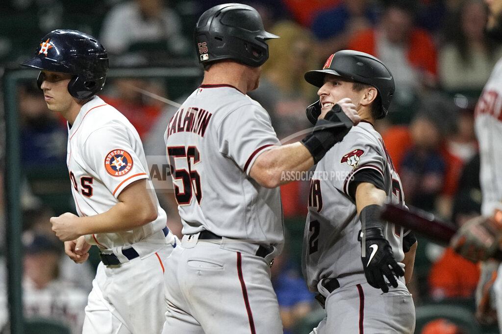 David J. Phillip Arizona Diamondbacks' Daulton Varsho, right, celebrates with Kole Calhoun (56) after both scored on Varsho's two-run home run against the Houston Astros during the 10th inning of a baseball game Saturday, Sept. 18, 2021, in Houston. (AP Photo/David J. Phillip)