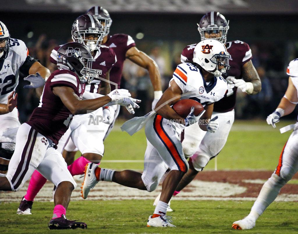 Rogelio V. Solis Auburn wide receiver Ryan Davis (23) runs after a pass reception while being pursued by Mississippi State defenders during the second half of their NCAA college football game in Starkville, Miss., Saturday, Oct. 6, 2018. Mississippi State won 23-9. (AP Photo/Rogelio V. Solis)