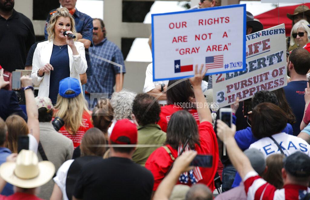 Shelley Luther, owner of Salon Á la Mode in Dallas speaks to the crowd during the Set Texas Free Rally at Dealey Plaza in Dallas, on Saturday, May 9, 2020. (Vernon Bryant /The Dallas Morning News via AP)