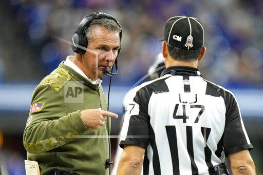Jacksonville Jaguars head coach Urban Meyer talks with line judge Tim Podraza (47) in the second half of an NFL football game against the Indianapolis Colts in Indianapolis, Sunday, Nov. 14, 2021. (AP Photo/AJ Mast)
