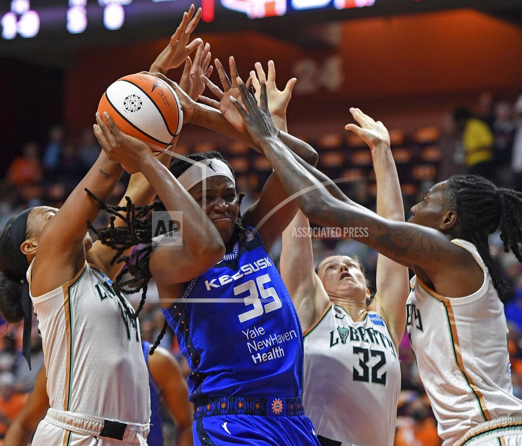 Sean D. Elliot Connecticut Sun forward Jonquel Jones (35) works between New York Liberty defenders Betnijah Laney, left, Sami Whitcomb (32) and Natasha Howard during the first half of a WNBA basketball game Wednesday, Sept. 15, 2021, in Uncasville, Conn. (Sean D. Elliot/The Day via AP)