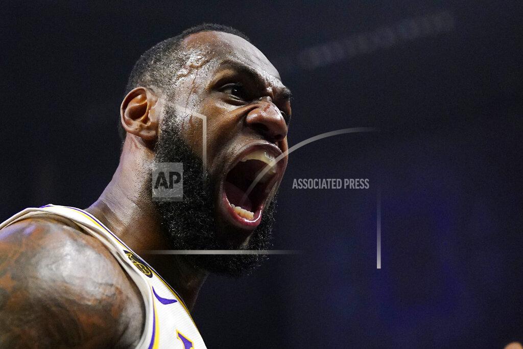 Mark J. Terrill FILE - In this March 8, 2020, file photo, Los Angeles Lakers forward LeBron James celebrates after scoring and drawing a foul during the second half of an NBA basketball game against the Los Angeles Clippers in Los Angeles. James was announced Saturday, Dec. 26, as the winner of The Associated Press’ Male Athlete of the Year award for a record-tying fourth time. (AP Photo/Mark J. Terrill, File)