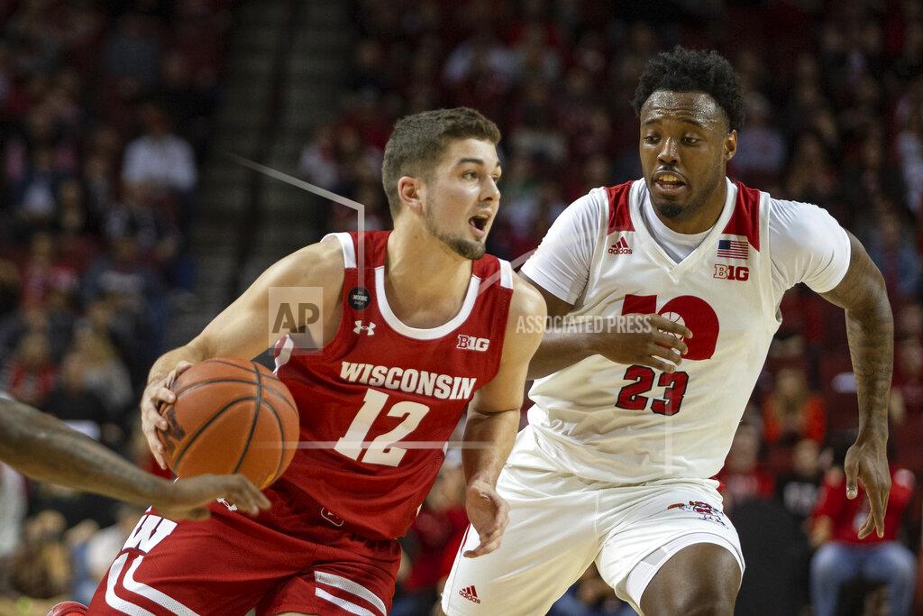 John Peterson Wisconsin guard Trevor Anderson (12) drives to the basket against Nebraska guard Jervay Green (23) during the first half of an NCAA college basketball game in Lincoln, Neb., Saturday, Feb. 15, 2020. (AP Photo/John Peterson)