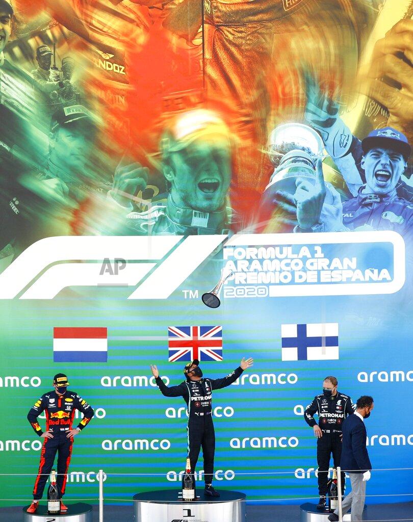Alejandro Garcia Winner Mercedes driver Lewis Hamilton of Britain, center, celebrates on the podium flanked by second placed Red Bull driver Max Verstappen of the Netherlands, left, and third placed Mercedes driver Valtteri Bottas of Finland after the Formula One Grand Prix at the Barcelona Catalunya racetrack in Montmelo, Spain, Sunday, Aug. 16, 2020. (Alejandro Garcia, Pool via AP)