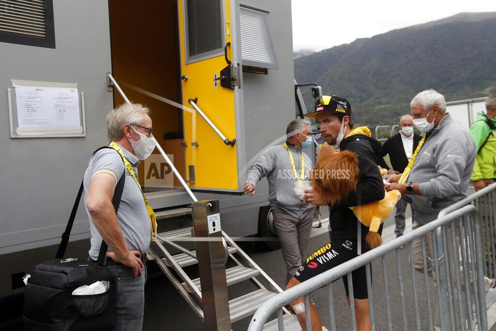 Christophe Ena Slovenia's Primoz Roglic waits outside the doping control facility after the ninth stage of the Tour de France cycling race over 153 kilometers (95 miles), with start in Pau and finish in Laruns, Sunday, Sept. 6, 2020. (AP Photo/Christophe Ena)