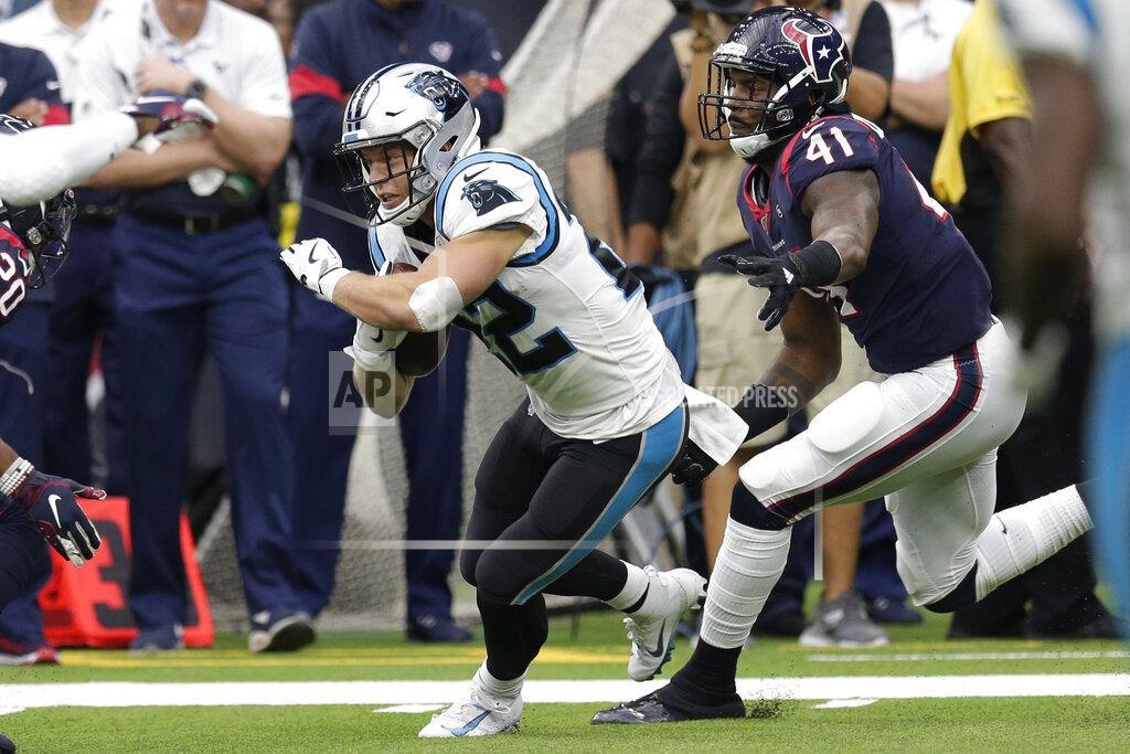 Carolina Panthers running back Christian McCaffrey (22) runs past Houston Texans inside linebacker Zach Cunningham (41) during the first half of an NFL football game Sunday, Sept. 29, 2019, in Houston. (AP Photo/Michael Wyke)