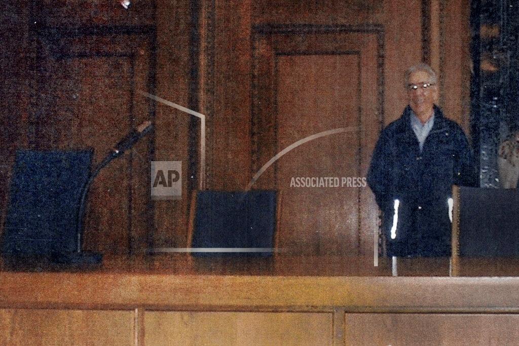 Uncredited In this May 2000 family photograph provided by Emily DiPalma Aho, Emily DiPalma Aho's father, Emilio DiPalma, stands in the spot where he stood guard as a 19-year-old U.S. Army infantryman at the Nuremberg Nazi war crimes trials. Emilio DiPalma died last month at the age of 93 after contracting the coronavirus at the Holyoke Soldiers' Home in Massachusetts. (Courtesy of Emily DiPalma Aho via AP)