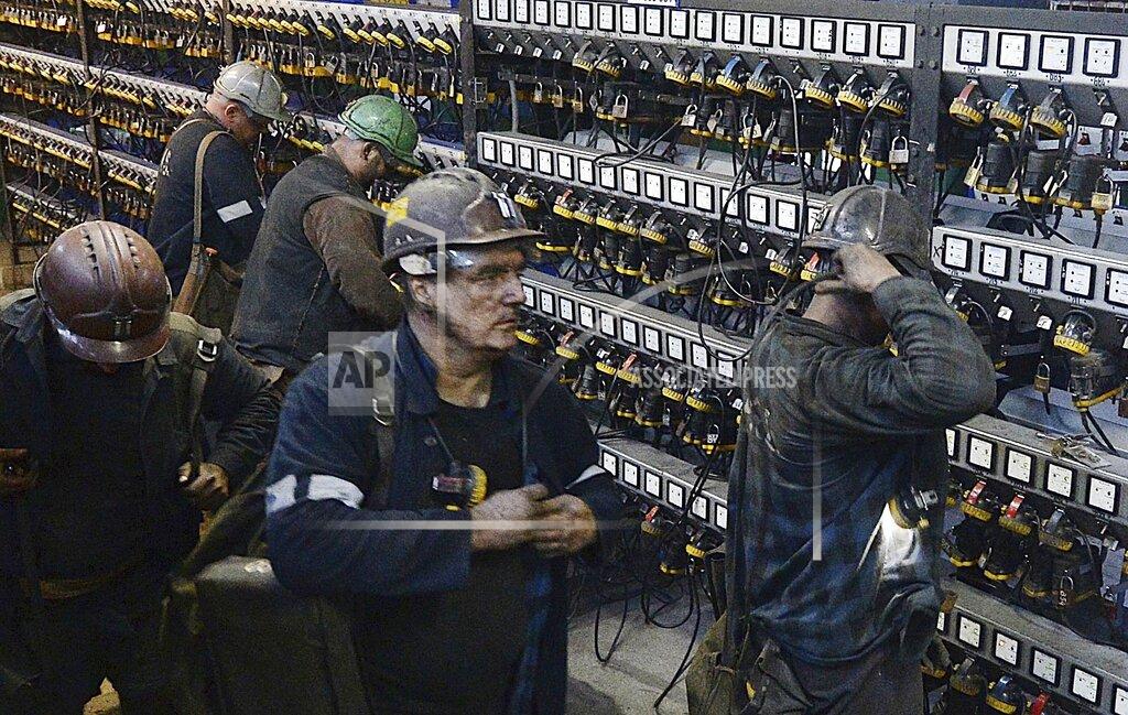 Czarek Sokolowski FILE - In this Nov. 21, 2018, file photo, miners put away their equipment after an underground shift at the Wujek coal mine in Katowice, in Poland's southern mining region of Silesia. The coronavirus has ripped through Poland's coal mines, where men descend deep underground in tightly packed elevators and work shoulder-to-shoulder. The virus hot spots, centered in the southern Silesia region, have paralyzed an already-troubled industry, forcing many to stay home from work and triggering a three-week closure of many state-run mines. (AP Photo/Czarek Sokolowski, File)
