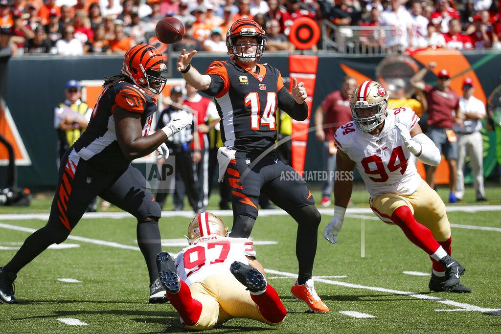 Frank Victores Cincinnati Bengals quarterback Andy Dalton (14) passes under pressure from San Francisco 49ers defensive end Nick Bosa (97) and defensive end Solomon Thomas (94) during the first half an NFL football game, Sunday, Sept. 15, 2019, in Cincinnati. (AP Photo/Frank Victores)