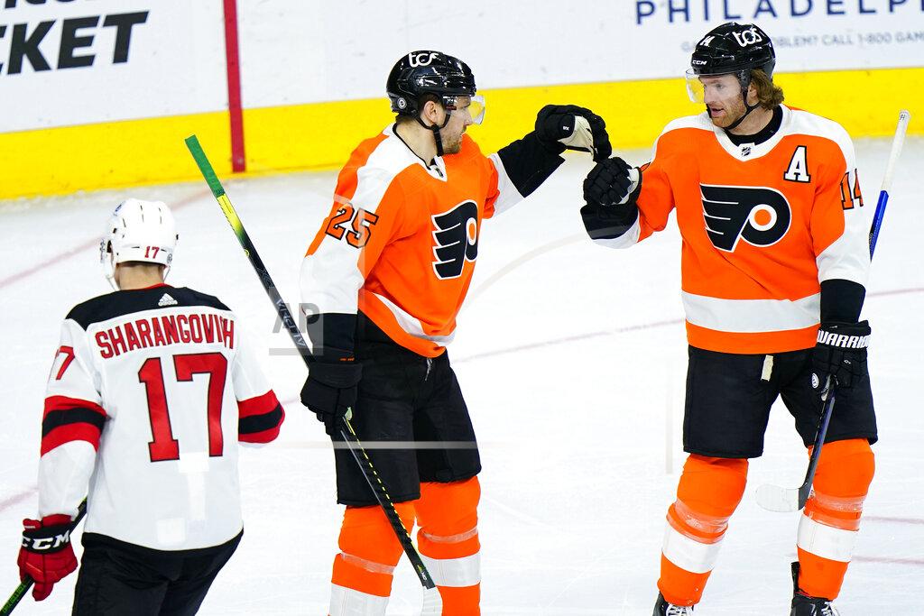 Matt Slocum Philadelphia Flyers' James van Riemsdyk (25) and Sean Couturier (14) celebrate past New Jersey Devils' Yegor Sharangovich (17) after a goal by van Riemsdyk during the third period of an NHL hockey game, Monday, May 10, 2021, in Philadelphia. (AP Photo/Matt Slocum)