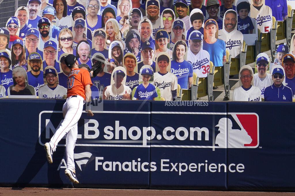 Marcio Jose Sanchez Houston Astros right fielder Kyle Tucker cannot catch a three-run home run hit by Oakland Athletics' Chad Pinder that lands in front of cutouts seated at Dodger Stadium during the seventh inning of Game 3 of a baseball American League Division Series in Los Angeles, Wednesday, Oct. 7, 2020. (AP Photo/Marcio Jose Sanchez)