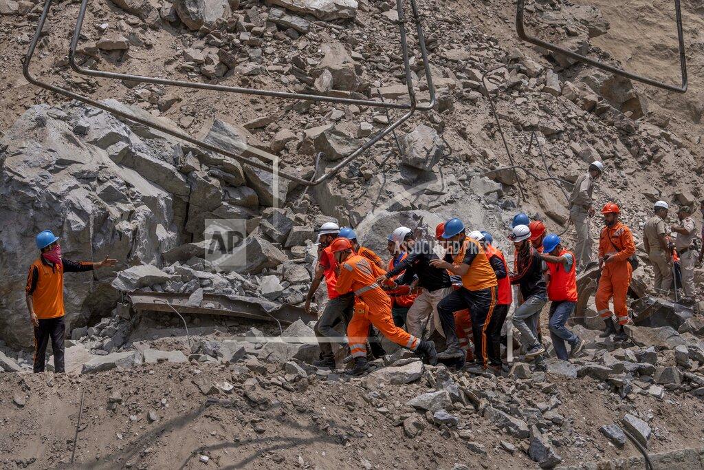 Dar Yasin Rescue workers carry the body of a victim at the site of a collapsed tunnel in Ramban district, south of Srinagar, Indian controlled Kashmir, Friday, May 20, 2022. An official in Indian-controlled Kashmir said Friday that 10 workers were trapped after part of a road tunnel collapsed in the Himalayan region. (AP Photo/Dar Yasin)