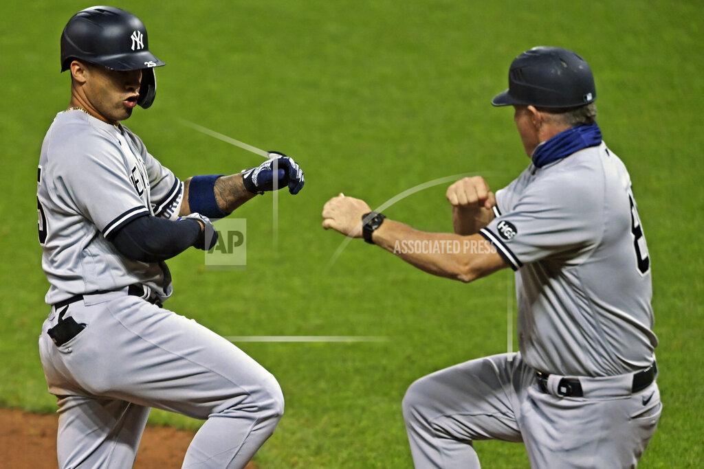 David Dermer New York Yankees' Gleyber Torres (25) is congratulated by Phil Nevin (88) after hitting a two-run home run in the fifth inning of Game 1 of an American League wild-card baseball series against the Cleveland Indians, Tuesday, Sept. 29, 2020, in Cleveland. (AP Photo/David Dermer)