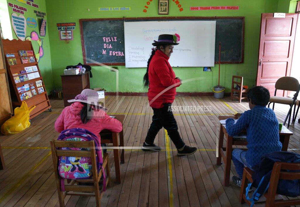 Martin Mejia Alicia Cisneros teaches the Quechua Indigenous language to primary school students at a public school in Licapa, Peru, Wednesday, Sept. 1, 2021. Peru´s new Education Minister Juan Cadillo says the government aims to increase the number of bilingual teachers like Cisneros in public schools. (AP Photo/Martin Mejia)