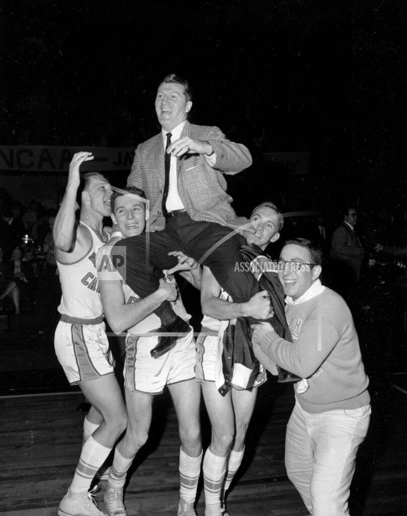 William P. Straeter FILE - In this March 23, 1957, file photo, North Carolina players hoist head coach Frank McGuire as they celebrate their 54-53 victory over Kansas in the NCAA college basketball championship final in Kansas City, Mo. (AP Photo/William P. Straeter, File)