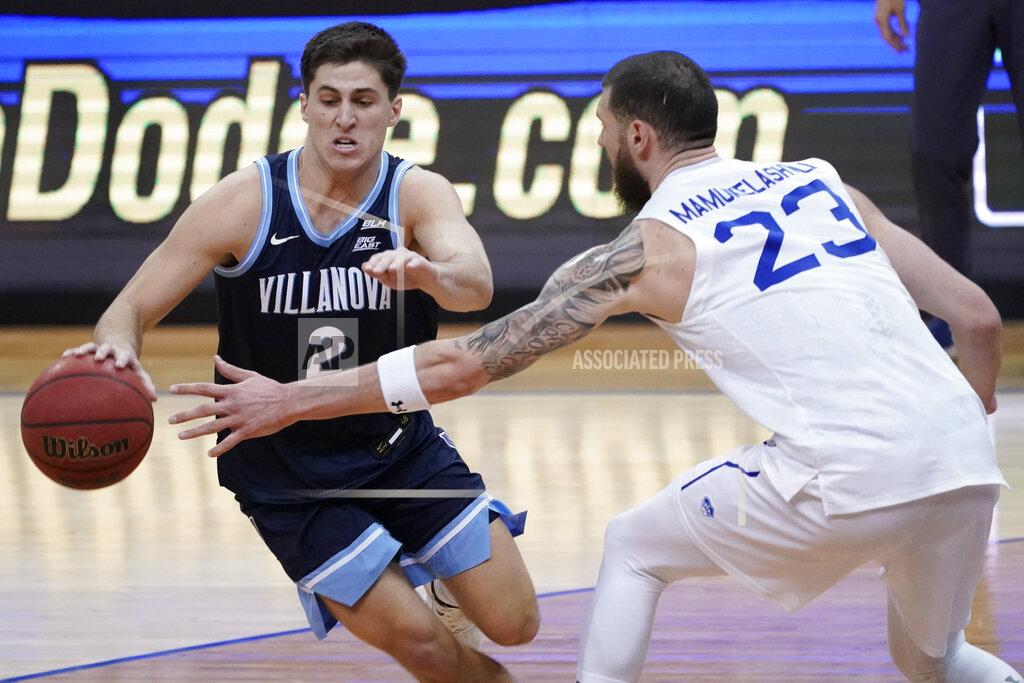 Mary Altaffer Villanova guard Collin Gillespie (2) drives against Seton Hall forward Sandro Mamukelashvili (23) during the second half of an NCAA college basketball game, Saturday, Jan. 30, 2021, in Newark, N.J. Villanova won 80-72. (AP Photo/Mary Altaffer)