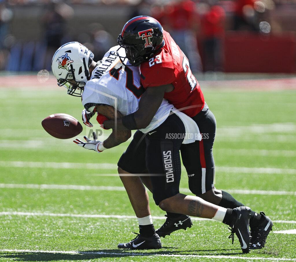 Brad Tollefson Texas Tech's Damarcus Fields (23) tackles Oklahoma State's Tylan Wallace (2) to break up a pass during the second half of an NCAA college football game Saturday, Oct. 5, 2019, in Lubbock, Texas. (AP Photo/Brad Tollefson)