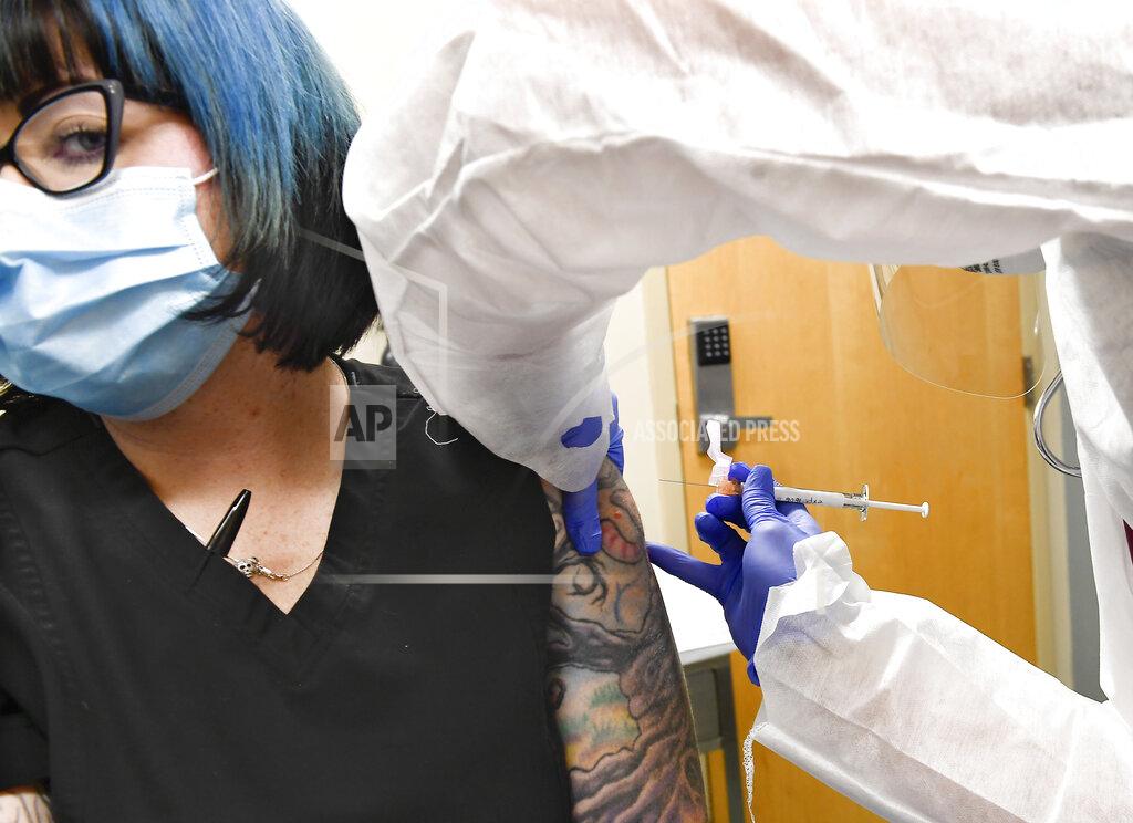 Hans Pennink FILE - In this Monday, July 27, 2020, file photo, Nurse Kathe Olmstead, right, gives volunteer Melissa Harting, of Harpursville, N.Y., an injection of a possible COVID-19 vaccine, developed by the National Institutes of Health and Moderna Inc., in Binghamton, N.Y. The U.S. is poised to give the green light as early as Friday, Dec. 18, to a second COVID-19 vaccine, a critical new weapon against the surging coronavirus. Doses of the vaccine developed by Moderna Inc. and the National Institutes of Health will give a much-needed boost to supplies as the biggest vaccination effort in the nation’s history continues.(AP Photo/Hans Pennink, File)