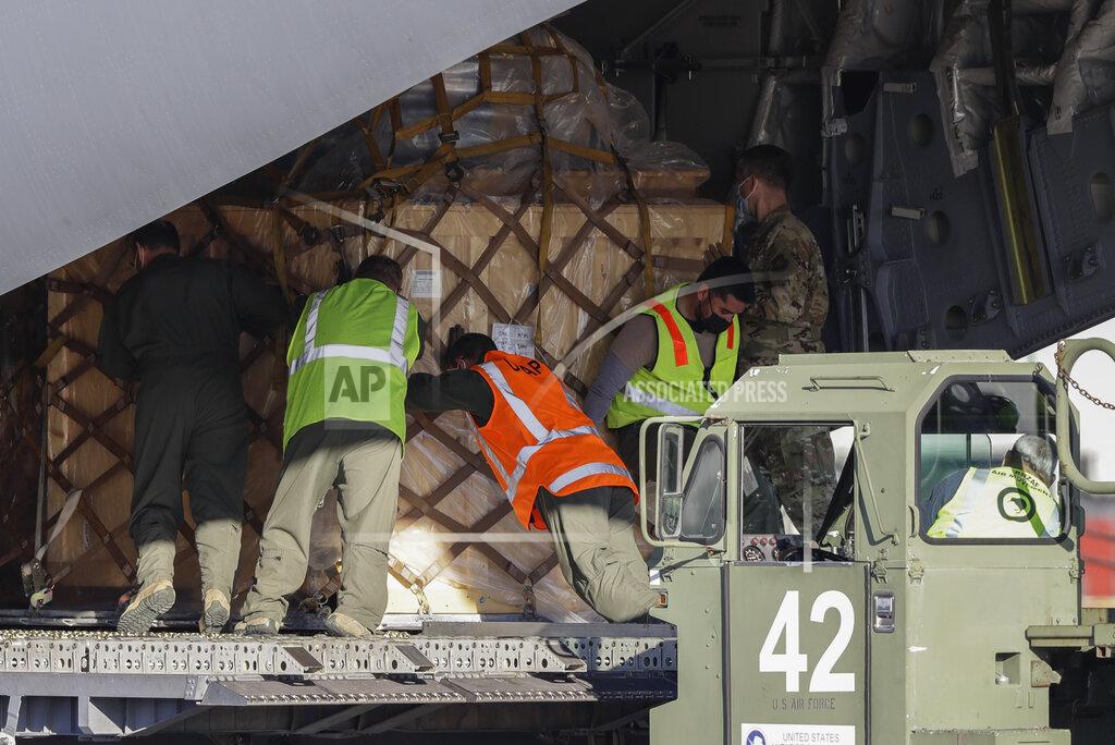 Mark Baker Ground crew load cargo onto a U.S. Air Force C-17 as they prepare to take the season's first flight to McMurdo Station in Antarctica from Christchurch Airport, New Zealand, Monday, Sept. 14, 2020. The first U.S. flight into Antarctica following months of winter darkness left from New Zealand Monday with crews extra vigilant about keeping out the coronavirus. (AP Photo/Mark Baker)