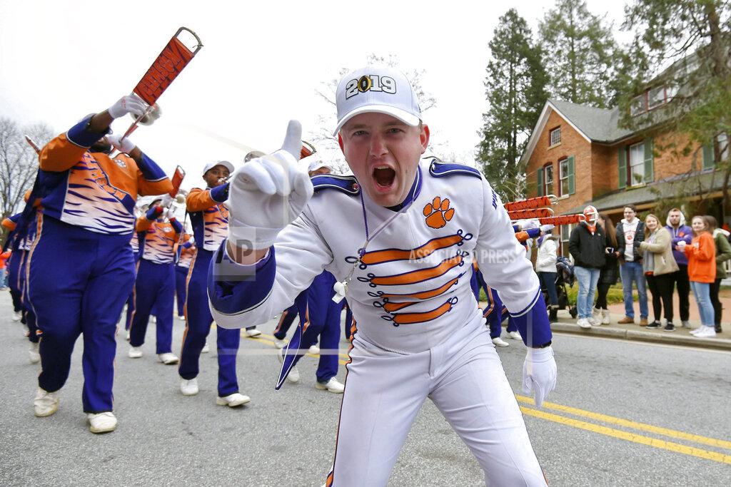 Richard Shiro FILE - In this Jan. 12, 2019, file photo, a Clemson band member shows his excitement during a parade honoring Clemson for winning the College Football Playoff championship game against Alabama, in Clemson, S.C. For the first time, the defending national champion Tigers are No. 1 in The Associated Press preseason Top 25 presented by Regions Bank, Monday, Aug. 19, 2019. (AP Photo/Richard Shiro, File)