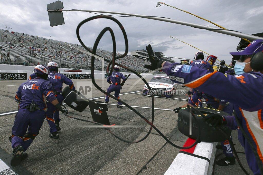 Charles Krupa The pit crew scrambles to work as driver Denny Hamlin rolls in for a pitstop during a NASCAR Cup Series auto race, Sunday, Aug. 2, 2020, at the New Hampshire Motor Speedway in Loudon, N.H. (AP Photo/Charles Krupa)