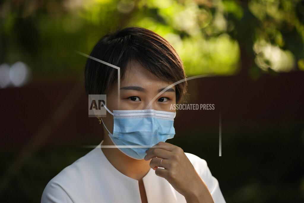 Ng Han Guan Teresa Xu prepares to attend a court session at the Chaoyang People's Court in Beijing, China, Friday, Sept. 17, 2021. After almost two years, the unmarried woman suing for the right to freeze her eggs in Beijing is getting her case heard in court Friday in a rare legal challenge against the country's restrictions on unmarried women in reproductive health. (AP Photo/Ng Han Guan)