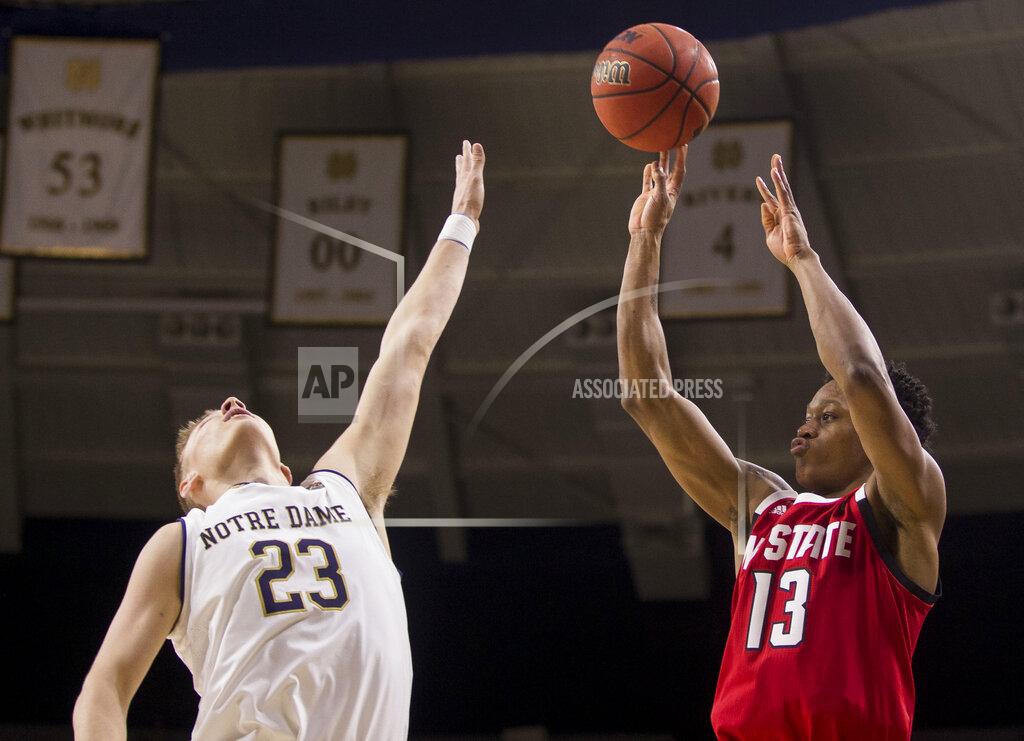 Robert Franklin North Carolina State's C.J. Bryce (13) shoots a 3-pointer over Notre Dame's Dane Goodwin (23) during the second half of an NCAA college basketball game Saturday, Jan. 19, 2019, in South Bend, Ind. North Carolina State won 77-73. (AP Photo/Robert Franklin)