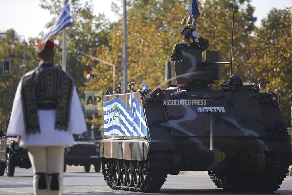 Giannis Papanikos A tank with a Greek Flag painted on the side parades through the streets of the northern port city of Thessaloniki, Greece, during a military parade, on Thursday, Oct. 28, 2021 .The parade is held to celebrate Greece's refusal to align itself with a belligerent fascist Italy in 1940 and instead fight a much stronger opponent, a decision which dragged it into World War II and eventually led to a brutal occupation by Nazi Germany. (AP Photo/Giannis Papanikos)
