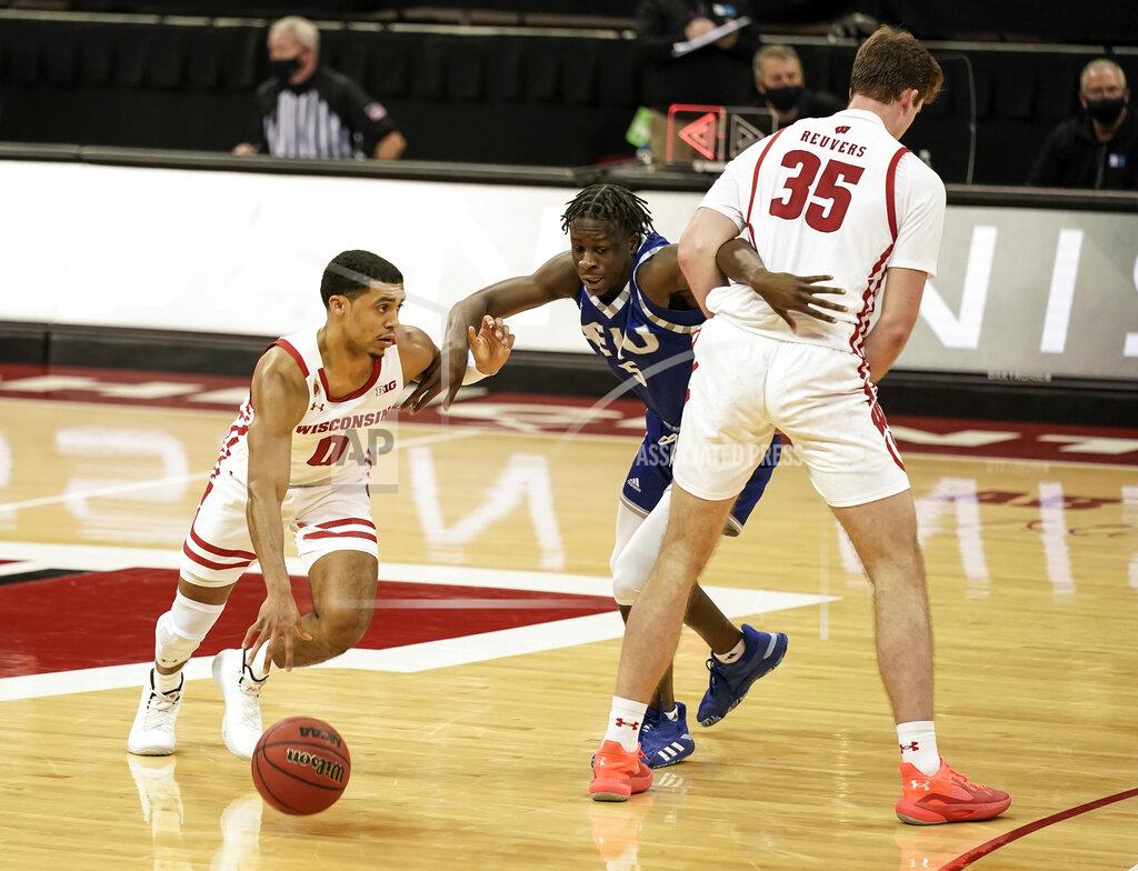 Andy Manis Wisconsin's D'Mitrik Trice (0) drives against Eastern Illinois' Junior Farquhar (5) as Wisconsin's Nate Reuvers (35) sets a screen during the second half of an NCAA college basketball game Wednesday, Nov. 25, 2020, in Madison, Wis. Wisconsin won 77-67. (AP Photo/Andy Manis)