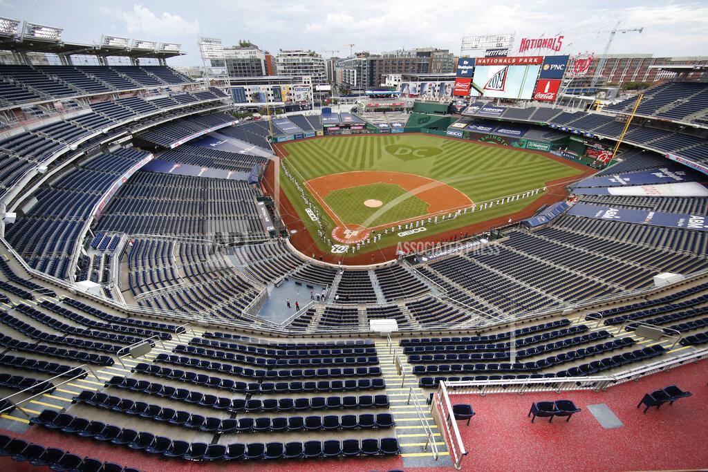Alex Brandon The New York Yankees and the Washington Nationals stand on the field before their opening day baseball game with no fans in the seats at Nationals Park, Thursday, July 23, 2020, in Washington. (AP Photo/Alex Brandon)