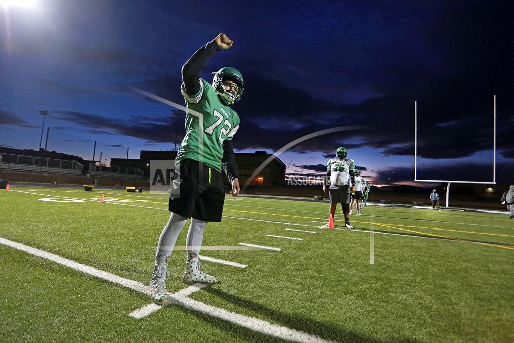 Cedar Attanasio Javin Lujan Lopez, 17, trains during a socially-distanced football practice at Pojoaque High School, in Pojoaque, N.M., Feb. 11, 2021. High school athletes trained in five-person pods for the past year because of the pandemic. (AP Photo/Cedar Attanasio)