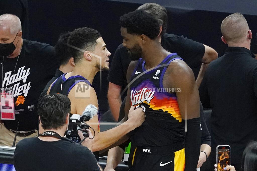 Matt York Phoenix Suns guard Devin Booker, left, celebrates with center Deandre Ayton after the Suns defeated the Los Angeles Clippers in Game 2 of the NBA basketball Western Conference Finals, Tuesday, June 22, 2021, in Phoenix. (AP Photo/Matt York)