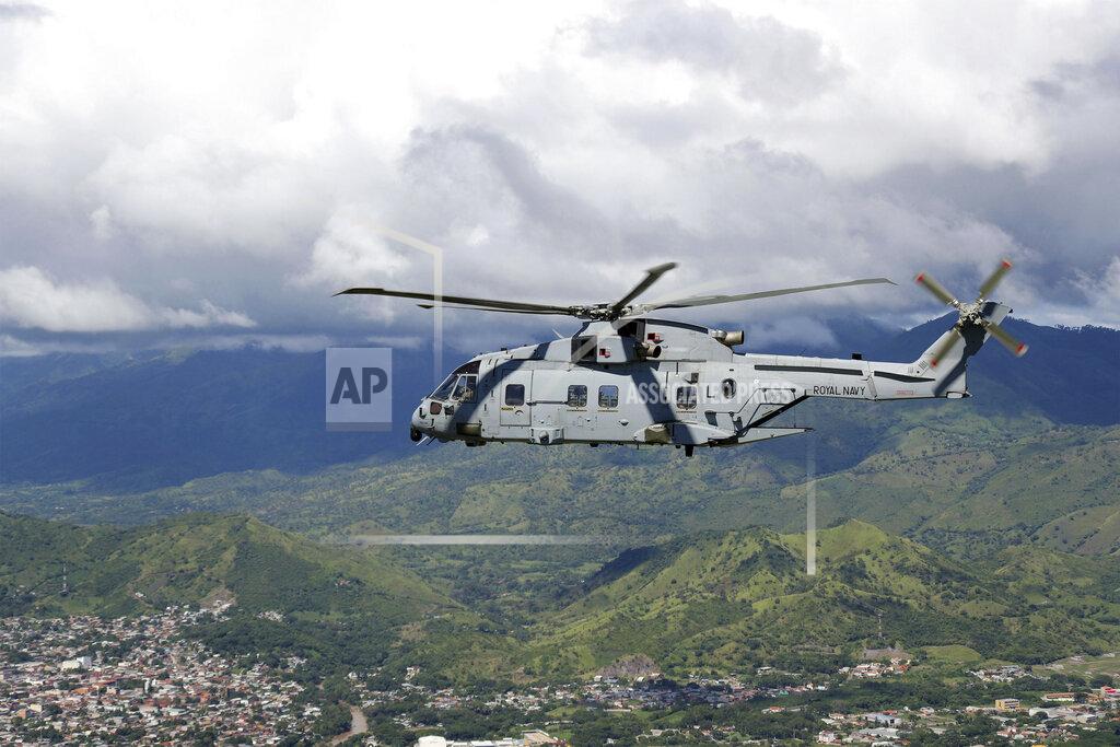 Lphot Robert Oates In this undated handout photo provided by the Ministry of Defence on Saturday, Nov. 21, 2020, a Merlin Helicopter from 845 Naval Air Squadron conducting damage surveys in Honduras. The devastation caused by Hurricane Iota is becoming clear as communications are restored after the second Category 4 hurricane in two weeks to blast Nicaragua’s Caribbean coast. The official death toll rose in Nicaragua with victims swept away by swollen rivers or buried in landslides. (LPhot Robert Oates/Ministry of Defence via AP)